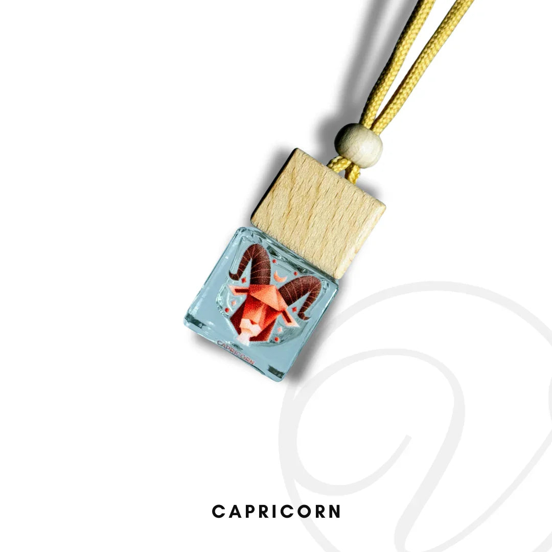 Capricorn zodiac fragrance bottle with wooden cap and yellow cord on white background