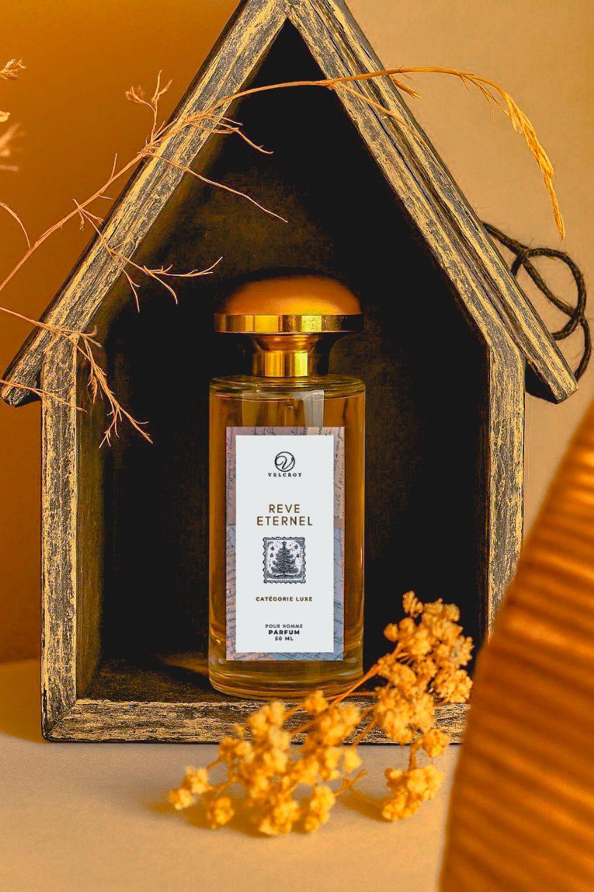 Luxury perfume bottle with gold cap and white label displayed in rustic wooden frame with dried flowers