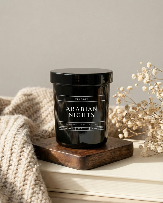 Candle labeled 'Arabian Nights' on a wooden coaster with a neutral background